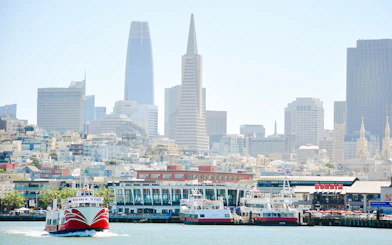 San Francisco skyline with ferry near Golden Gate Bridge cruise terminal.