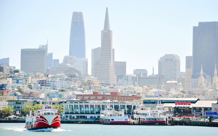 San Francisco skyline with ferry near Golden Gate Bridge cruise terminal.