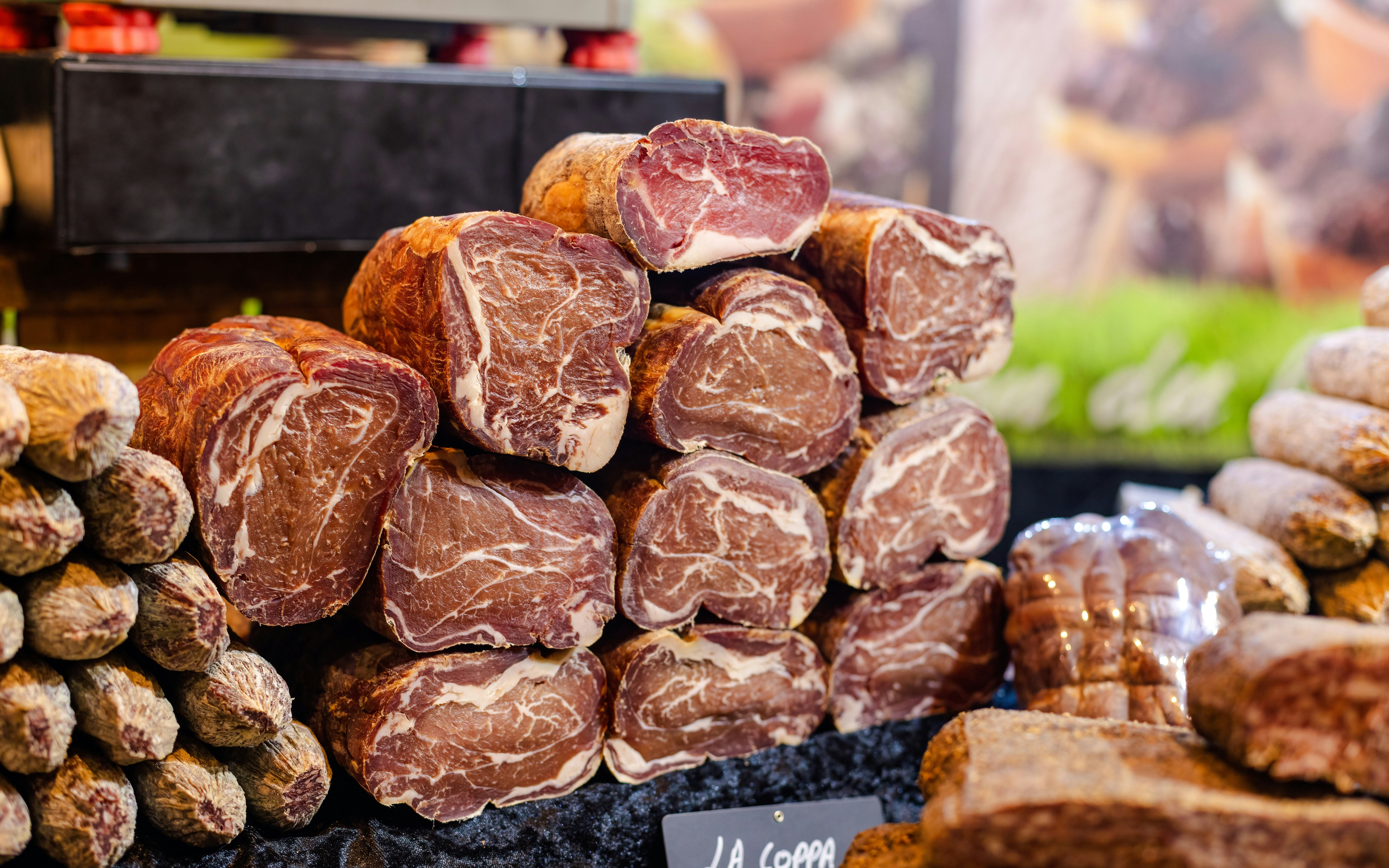 Cured meats displayed at a market stall in Ghent.