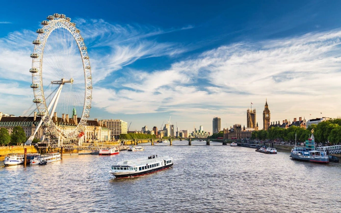 London Eye and Thames River with boats, view from the Halloween Afternoon Tea Bus Tour.