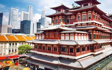 Buddha Tooth Relic Temple in Chinatown, Singapore with city skyline in the background.