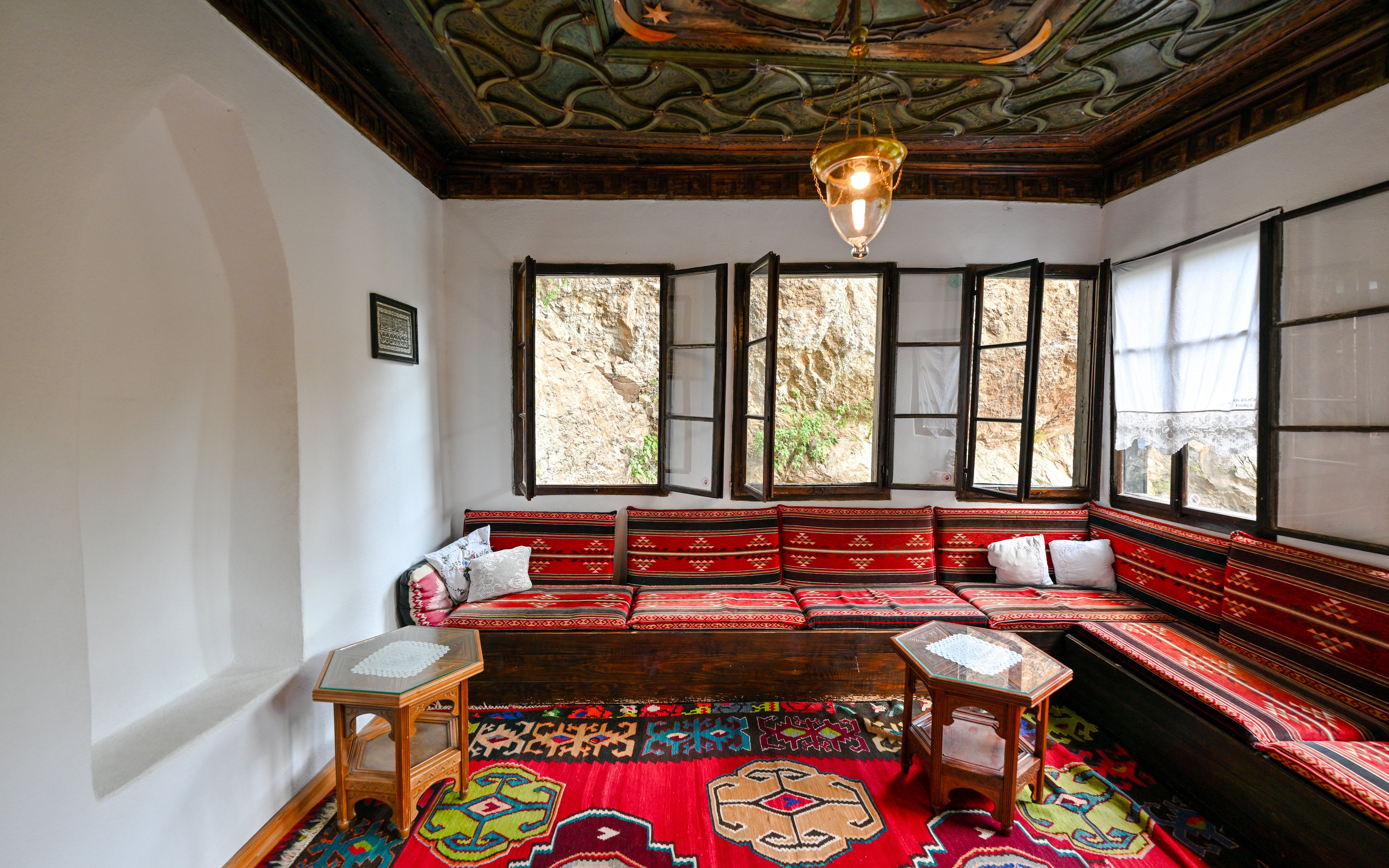 Inside seating area of Blagaj Dervish Tekke, Bosnia Herzegovina, with traditional decor.