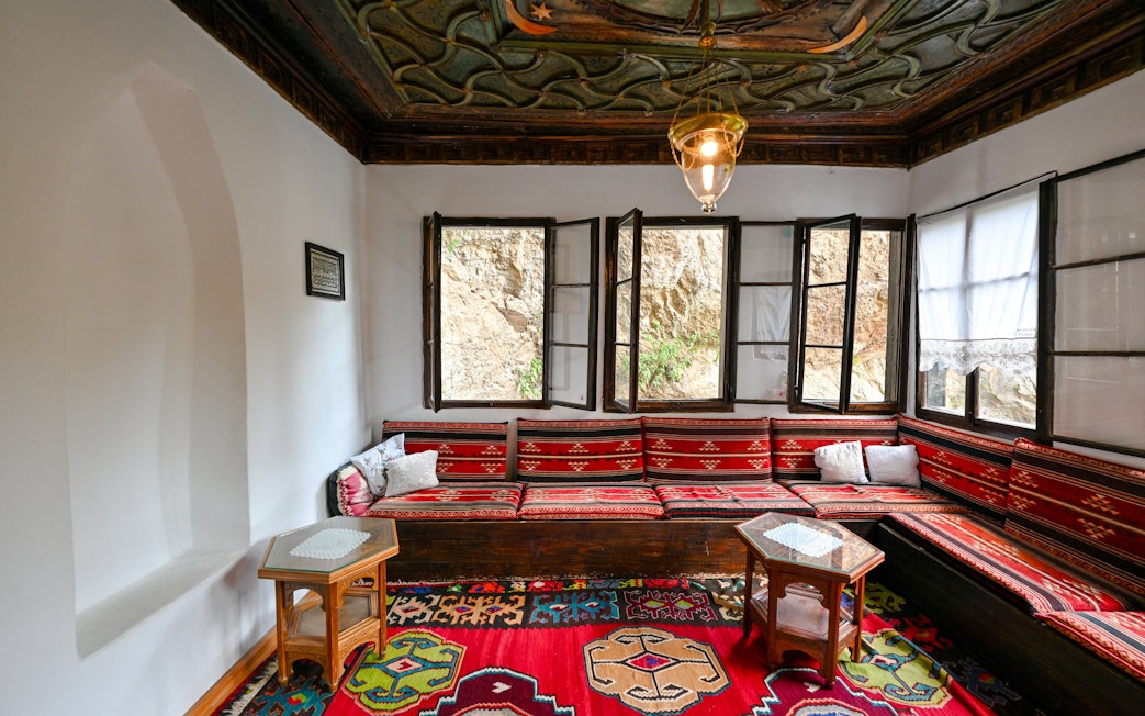 Inside seating area of Blagaj Dervish Tekke, Bosnia Herzegovina, with traditional decor.