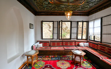Inside seating area of Blagaj Dervish Tekke, Bosnia Herzegovina, with traditional decor.