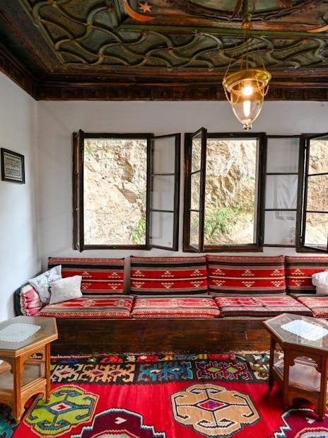 Inside seating area of Blagaj Dervish Tekke, Bosnia Herzegovina, with traditional decor.