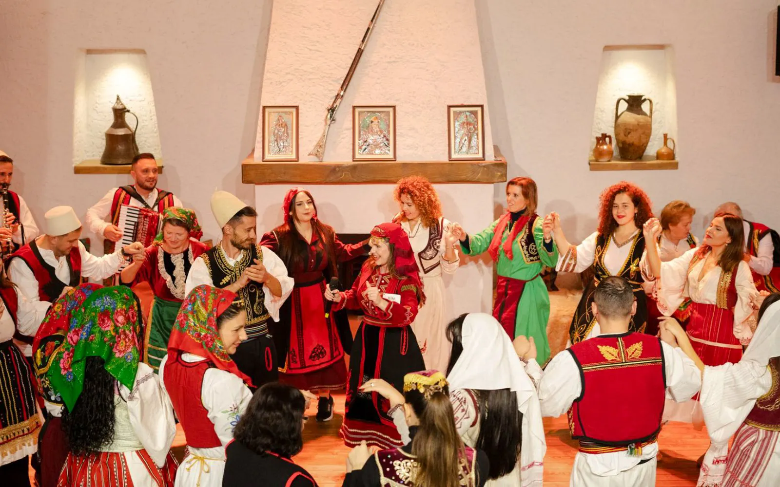 Performers in traditional attire dancing during Albanian Night Cultural Dance & Music Experience.