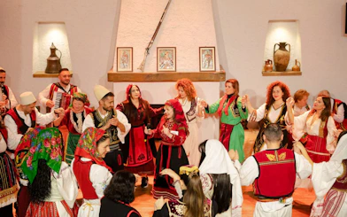 Performers in traditional attire dancing during Albanian Night Cultural Dance & Music Experience.