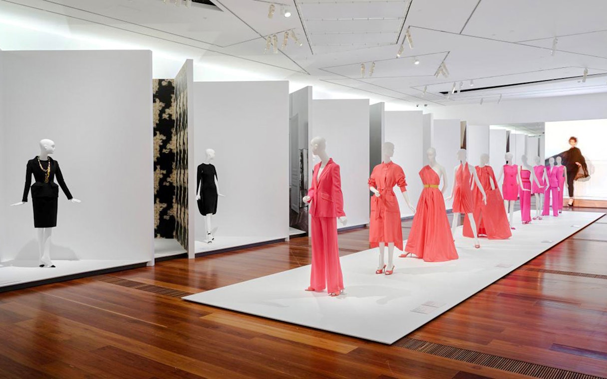 Mannequins displaying vibrant dresses at Martin Grant Exhibition.