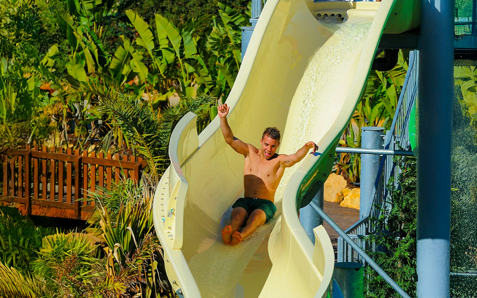 Tourist descending waterslide at Zoomarine Algarve water park, Portugal.