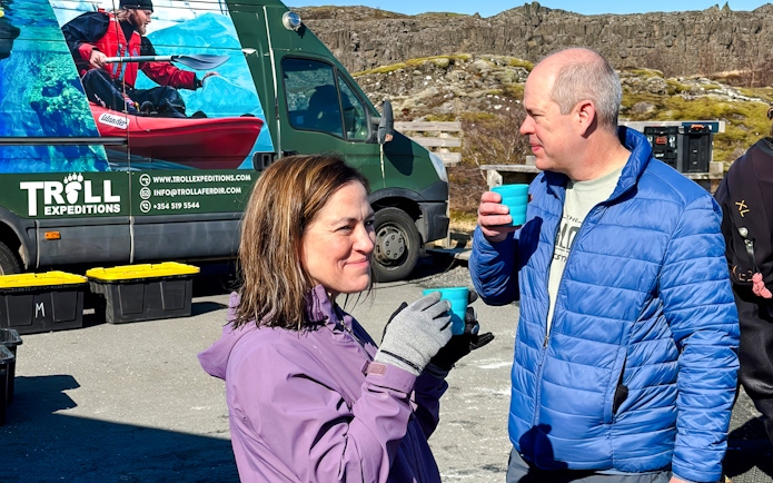 Guests enjoying refreshments near Silfra with Troll Expeditions van in the background.