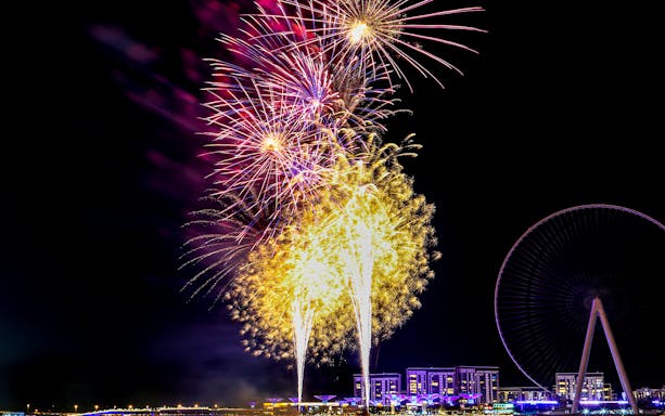 Dubai New Year 2024 fireworks display near Ain Dubai Ferris wheel.