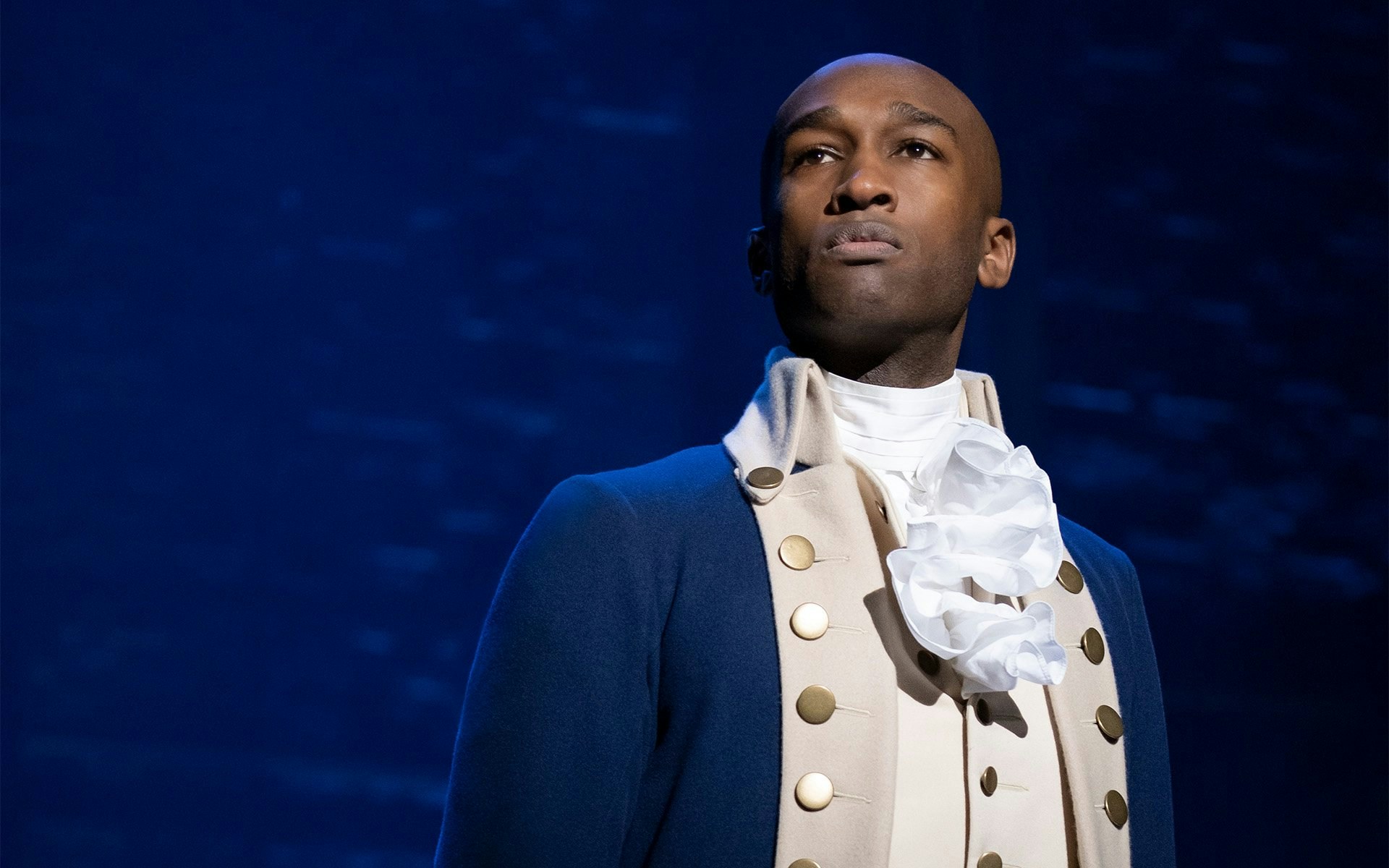 Performer in historical costume from the musical Hamilton.