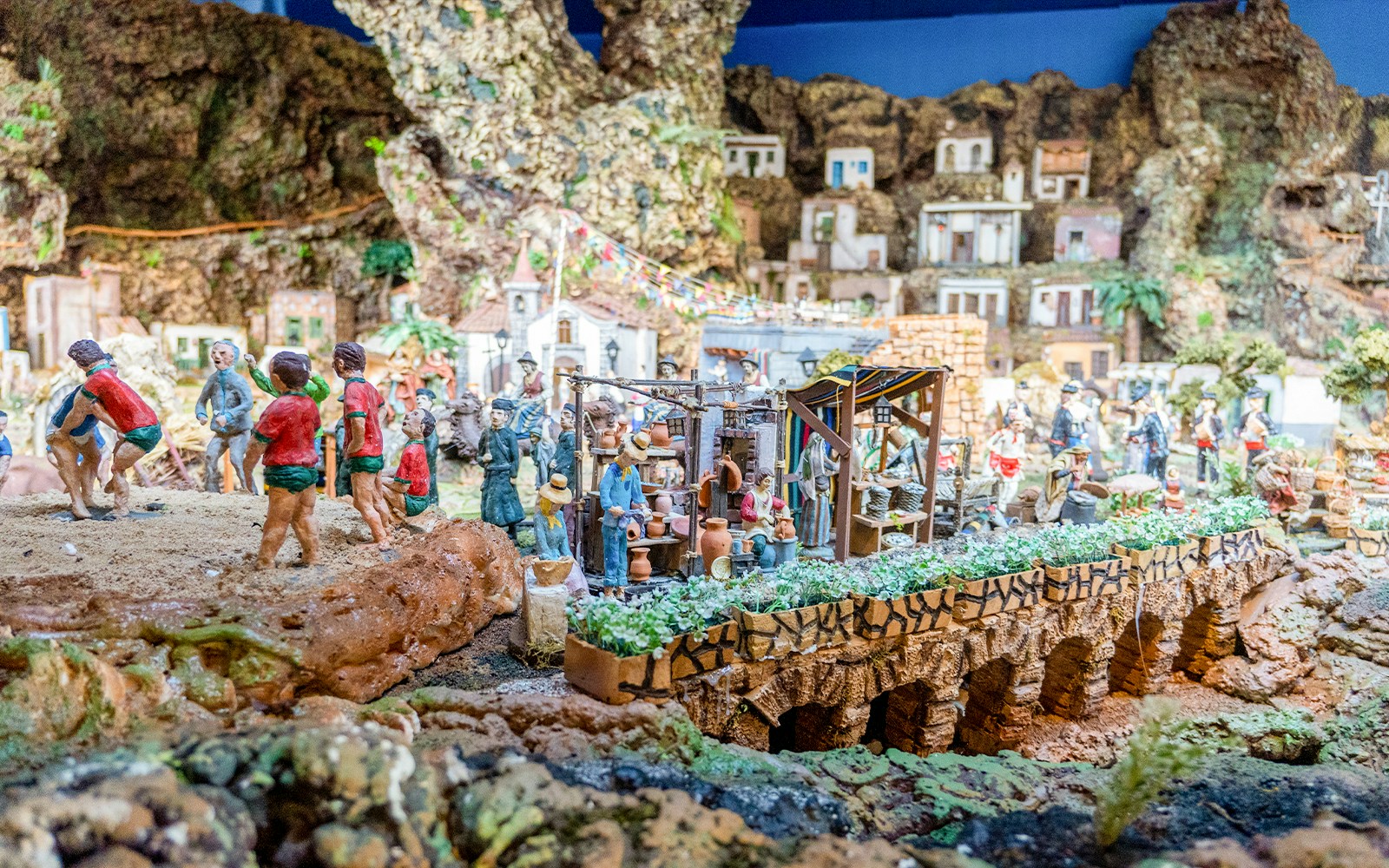 Nativity scene with figurines and village backdrop in Tenerife, Christmas display.