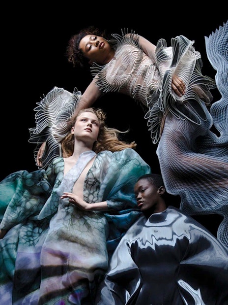 Futuristic fashion exhibit at ArtScience Museum, featuring intricate, flowing designs.