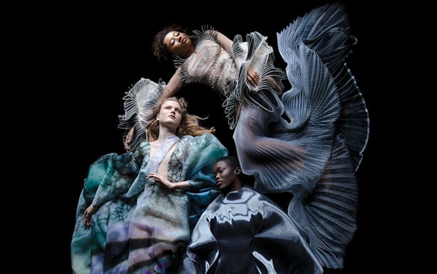 Futuristic fashion exhibit at ArtScience Museum, featuring intricate, flowing designs.