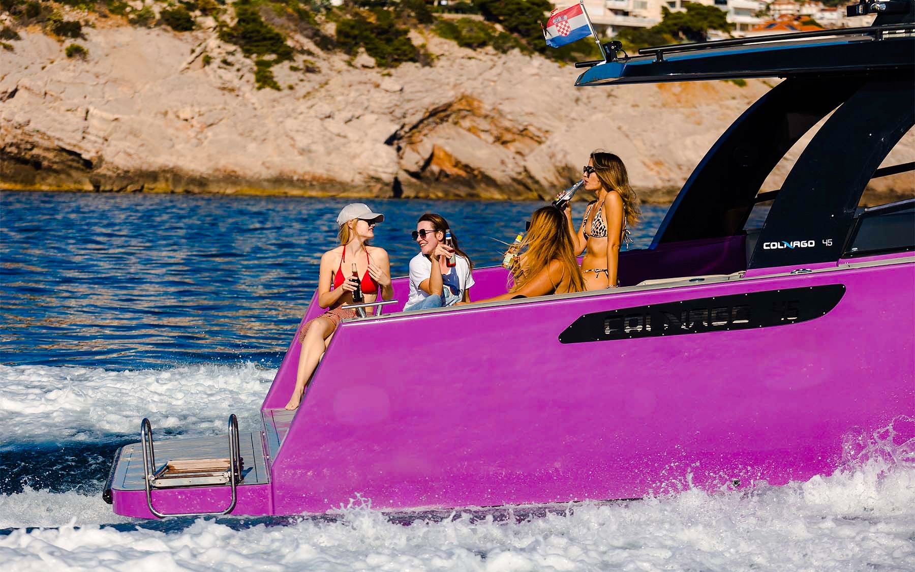 Boat ride with friends near Dubrovnik, Croatia, enjoying drinks on a purple boat.