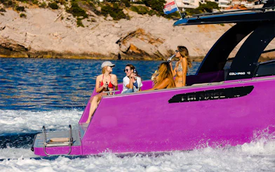 Boat ride with friends near Dubrovnik, Croatia, enjoying drinks on a purple boat.