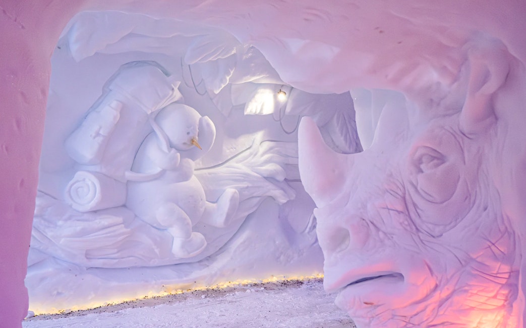 Snow sculptures of a snowman and rhinoceros at Snowman World, Santa Claus Village.