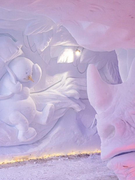 Snow sculptures of a snowman and rhinoceros at Snowman World, Santa Claus Village.
