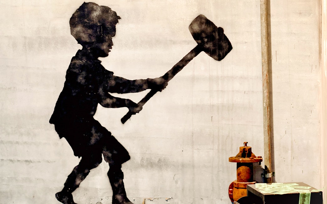 Silhouette of a child with a sledgehammer at the Banksy Museum.