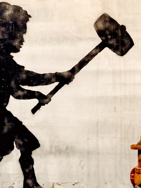 Silhouette of a child with a sledgehammer at the Banksy Museum.