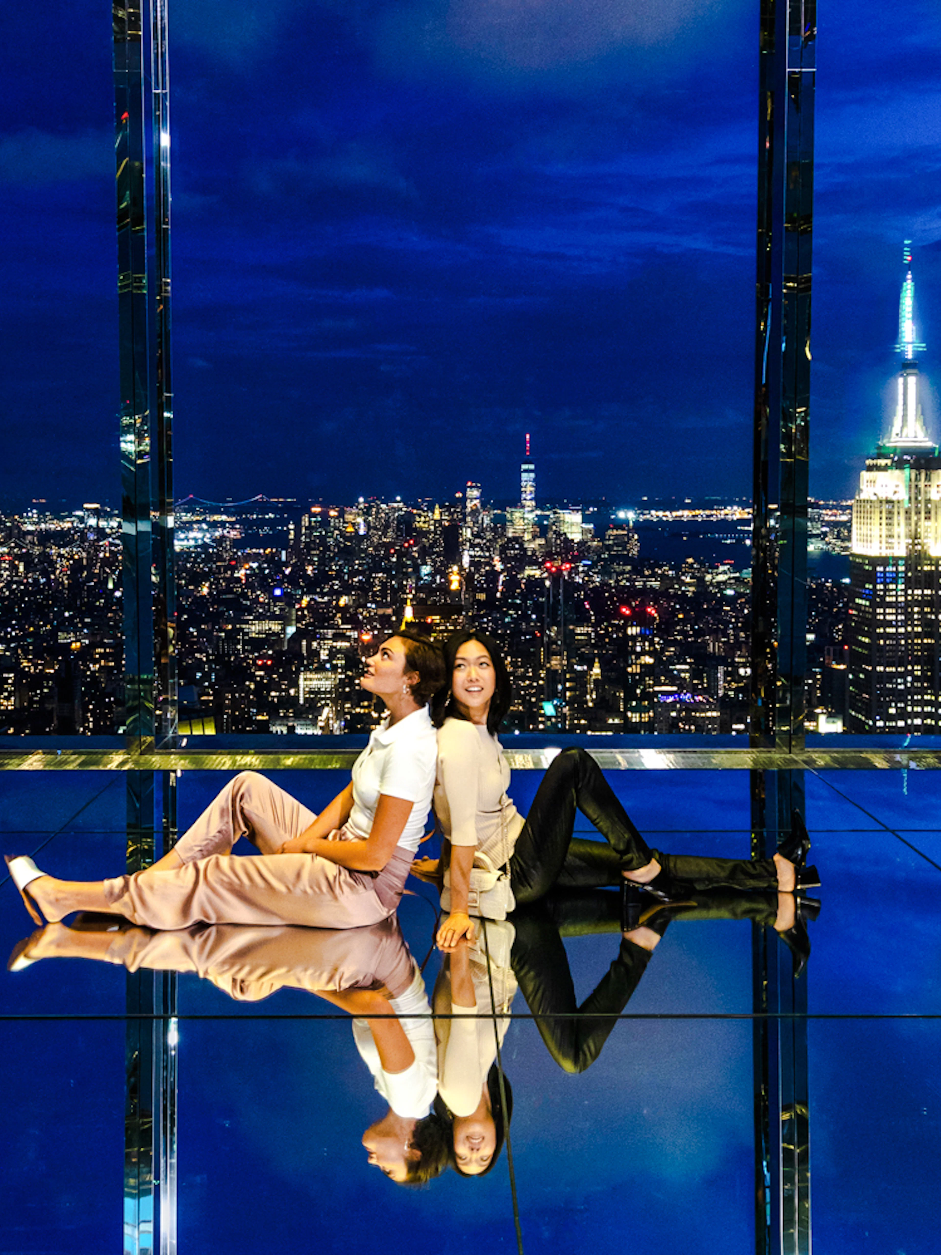 Guests enjoying the night view at Summit One Vanderbilt with city skyline.