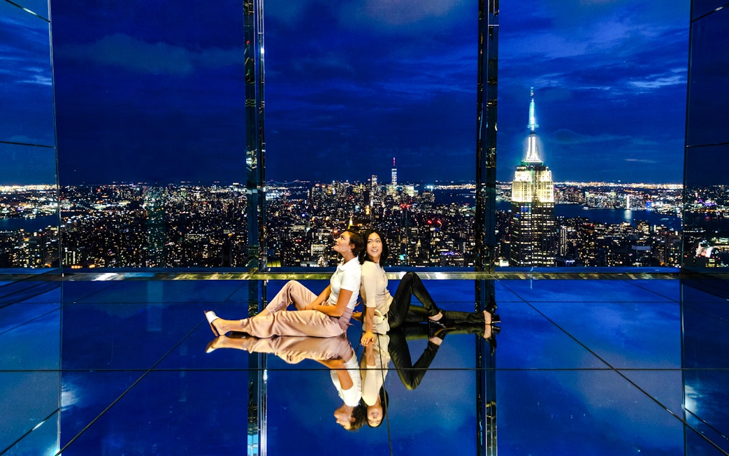 Guests enjoying the night view at Summit One Vanderbilt with city skyline.