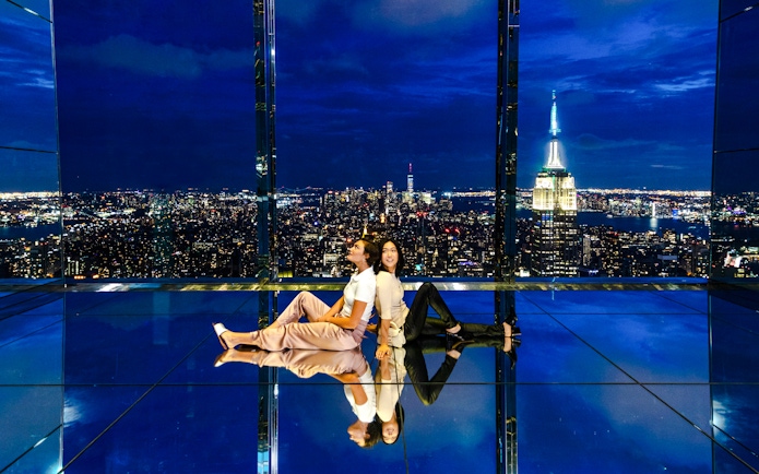 Guests enjoying the night view at Summit One Vanderbilt with city skyline.