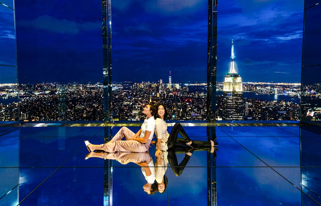 Guests enjoying the night view at Summit One Vanderbilt with city skyline.