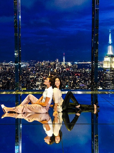 Guests enjoying the night view at Summit One Vanderbilt with city skyline.