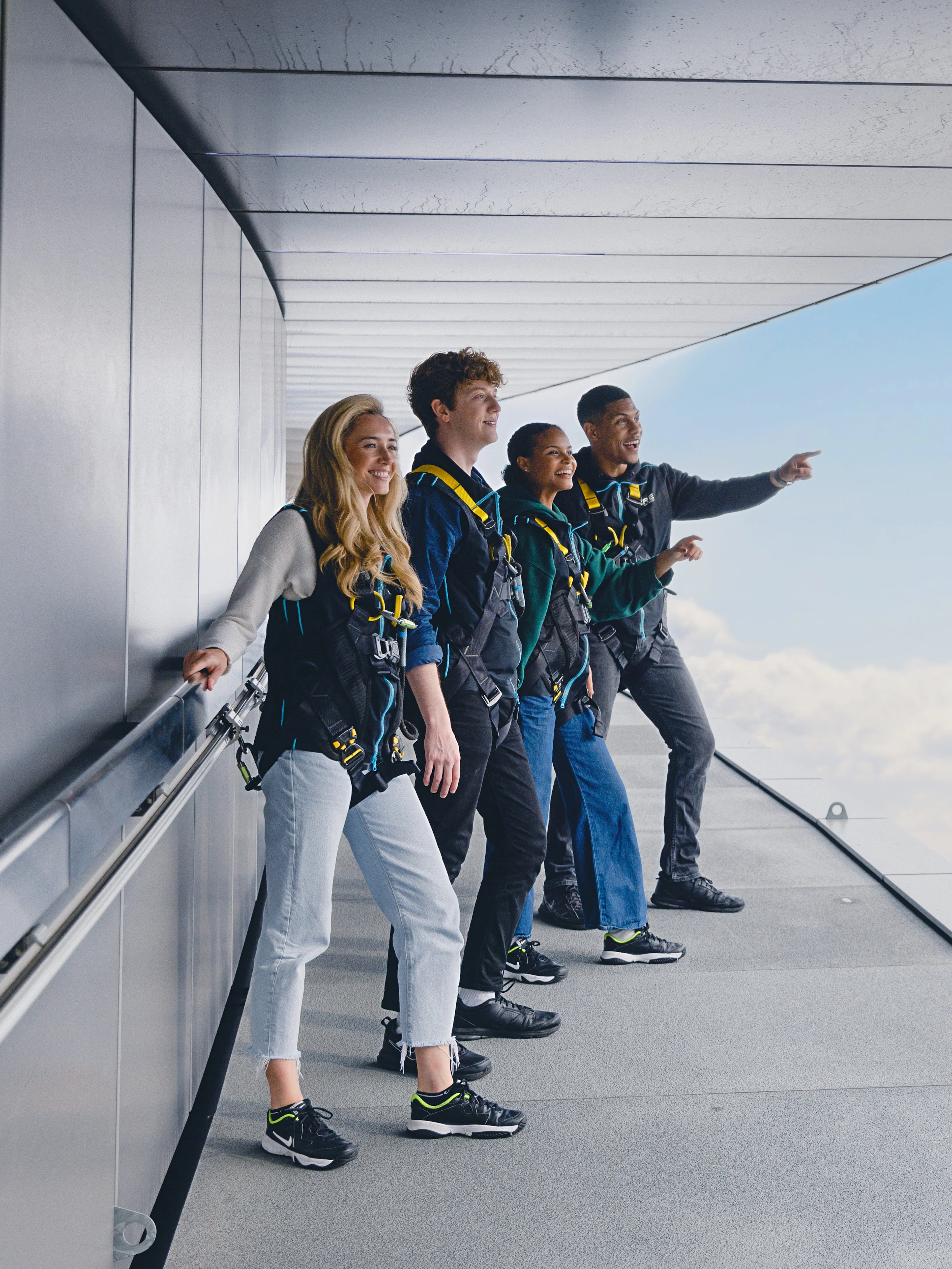Participants on the Dare Skywalk overlooking cityscape.