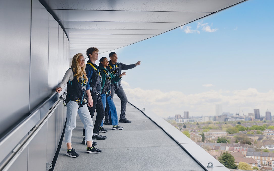 Participants on the Dare Skywalk overlooking cityscape.