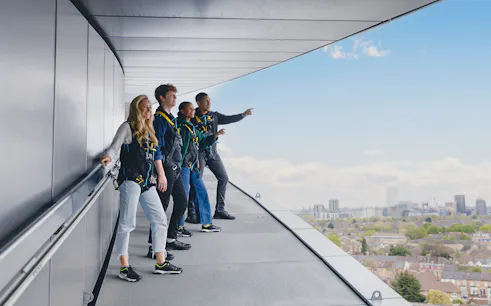Participants on the Dare Skywalk overlooking cityscape.