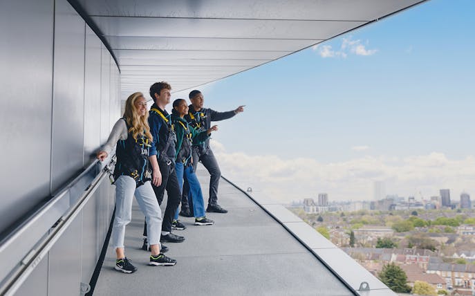Participants on the Dare Skywalk overlooking cityscape.