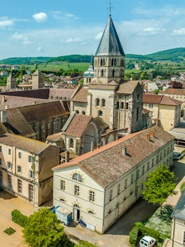 Abbaye de Cluny aerial view, showcasing historic architecture and surrounding landscape in Cluny, France.