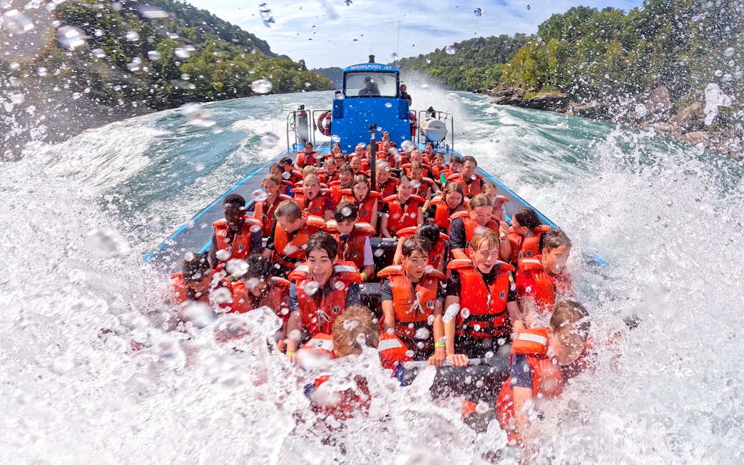 Guests enjoying a thrilling Whirlpool Jet Boat Tour in the Niagara Gorge, Canada.