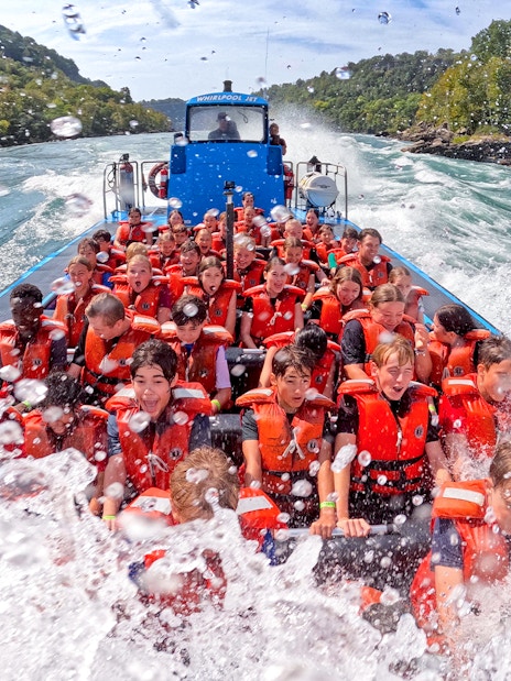 Guests enjoying a thrilling Whirlpool Jet Boat Tour in the Niagara Gorge, Canada.