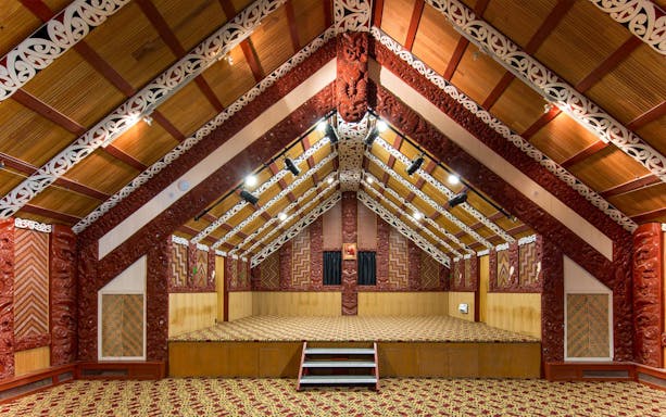 Traditional Māori meeting house interior at Te Puia, Rotorua, New Zealand.