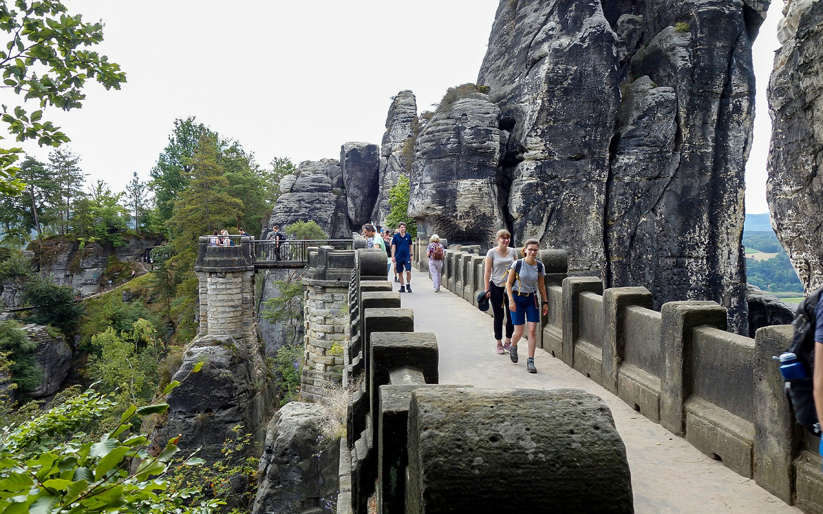 Hikers crossing the Bastei Bridge in Saxon Switzerland National Park.