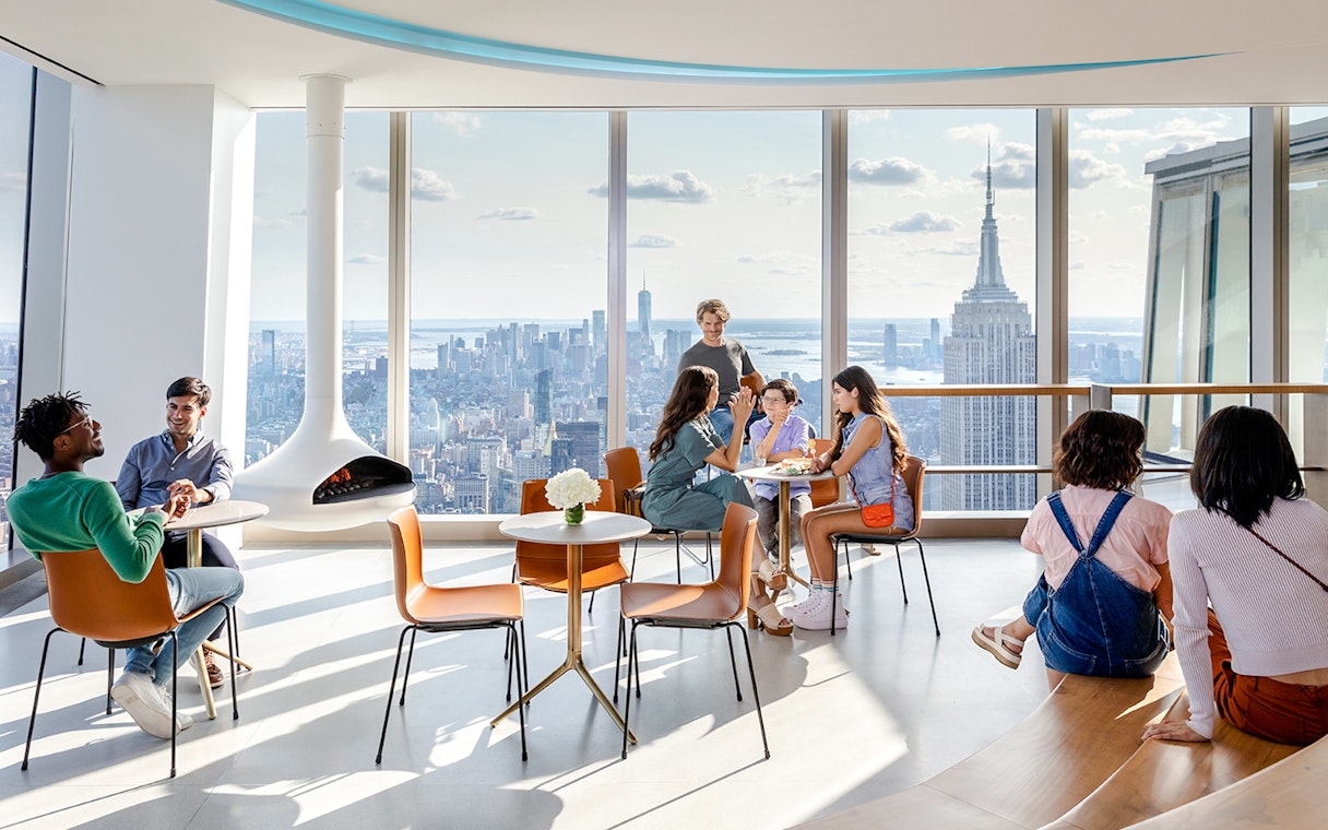 Guests enjoying the view at Cafe APRÈS with the Empire State Building in the background.
