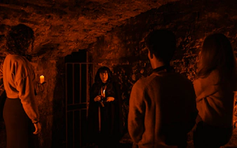 Guests exploring underground vaults on the Doomed, Dead and Buried tour in Edinburgh.