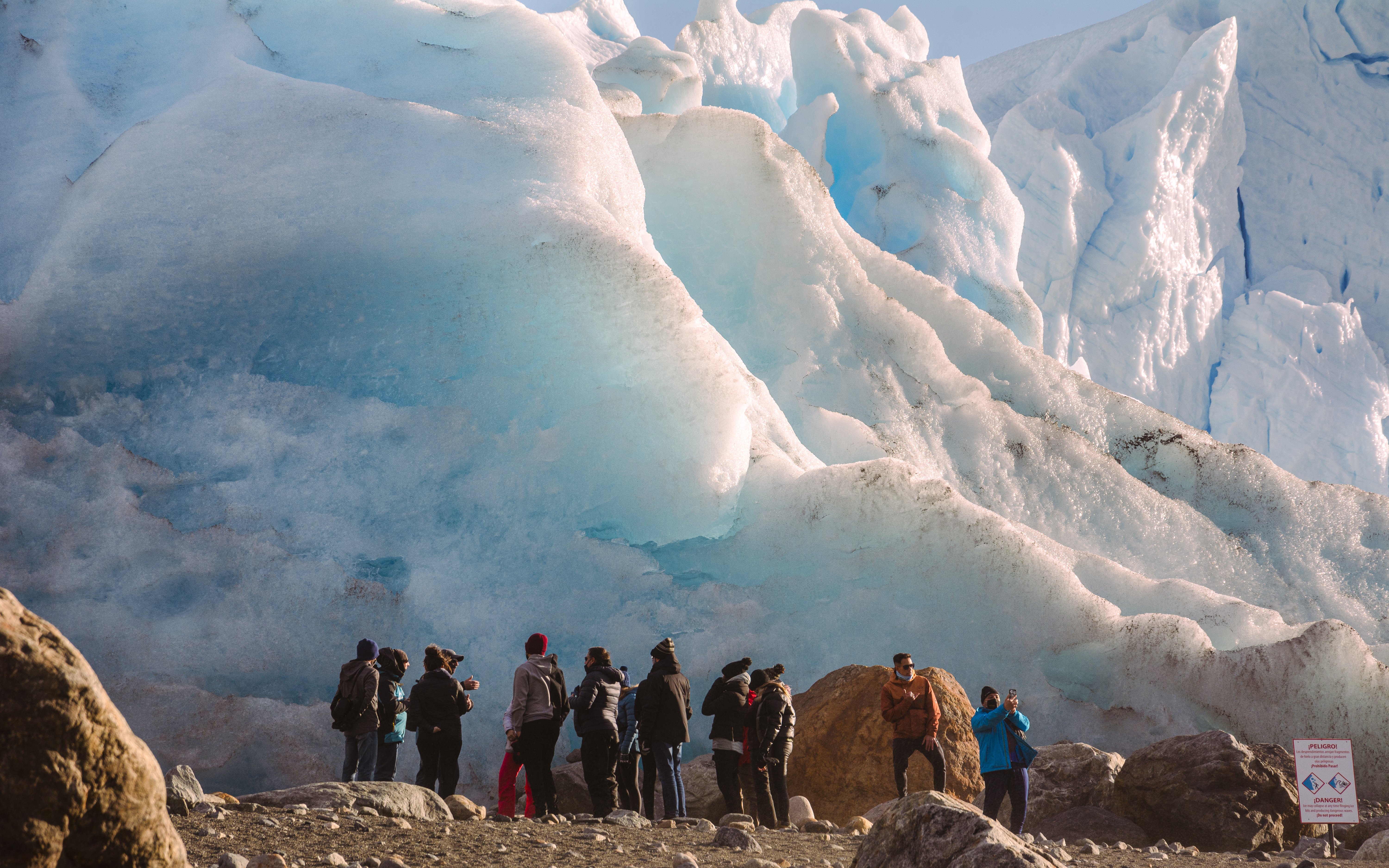 Guests standing near a large glacier on Safari Azul Guided Tour.
