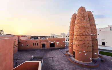 Pigeon towers at Katara Cultural Village in Doha, Qatar, during sunset.