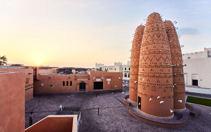 Pigeon towers at Katara Cultural Village in Doha, Qatar, during sunset.