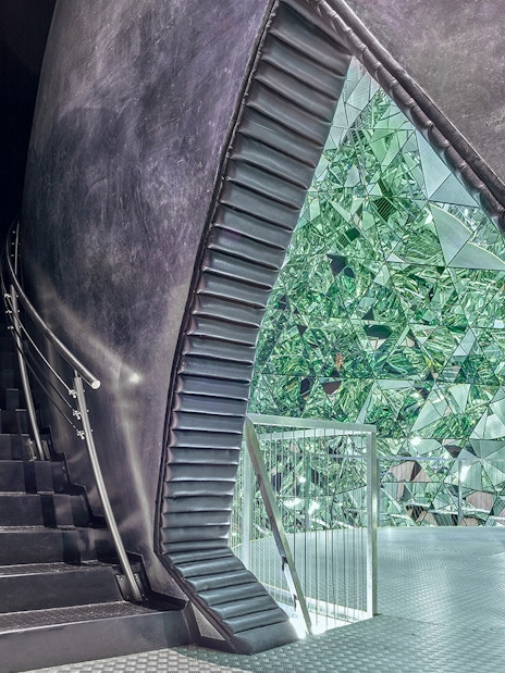 Staircase leading to a mirrored crystal installation at Swarovski Crystal Worlds.