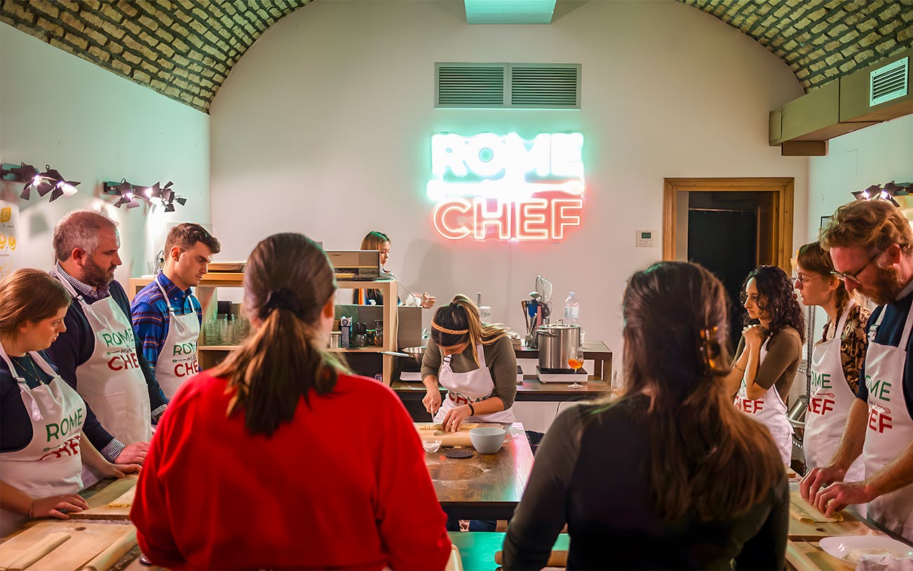 Participants in a Rome cooking class learning to make pasta.