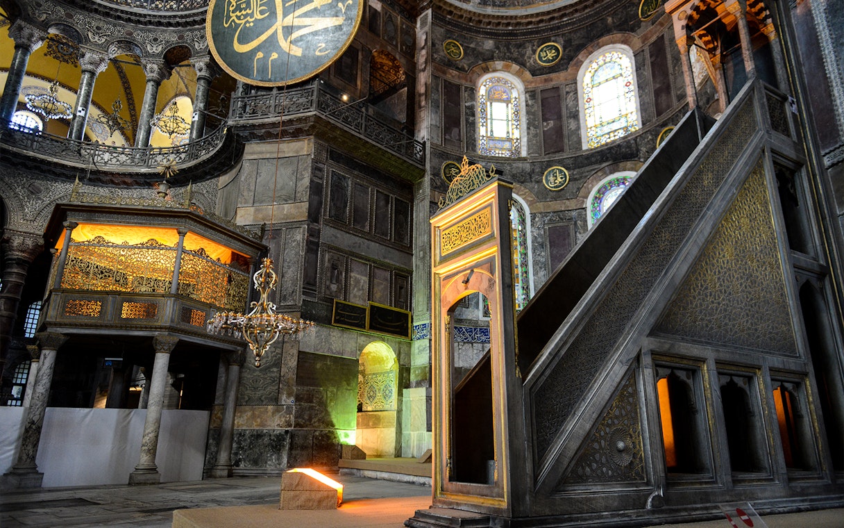 Hagia Sophia minbar with intricate carvings and stained glass windows in Istanbul, Turkey.