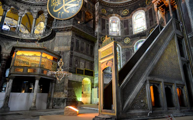 Hagia Sophia minbar with intricate carvings and stained glass windows in Istanbul, Turkey.