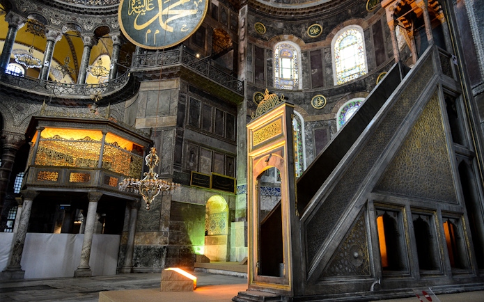 Hagia Sophia minbar with intricate carvings and stained glass windows in Istanbul, Turkey.
