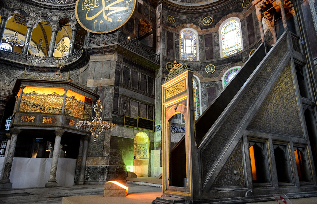 Hagia Sophia minbar with intricate carvings and stained glass windows in Istanbul, Turkey.